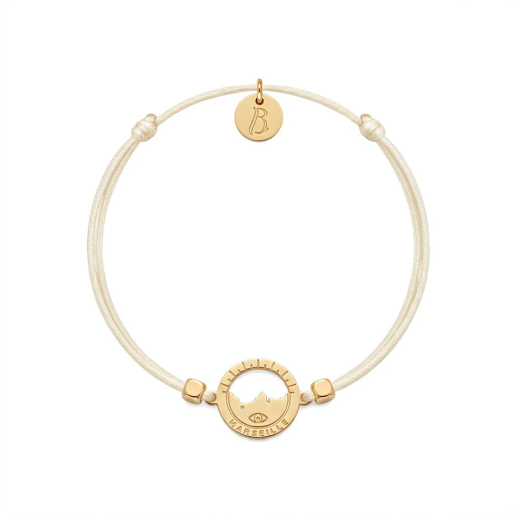 bracelet Les Catalans cordon nylon doré écru — médaille Marseille ajourée, bijou doré à l'or fin Ligne Bleue